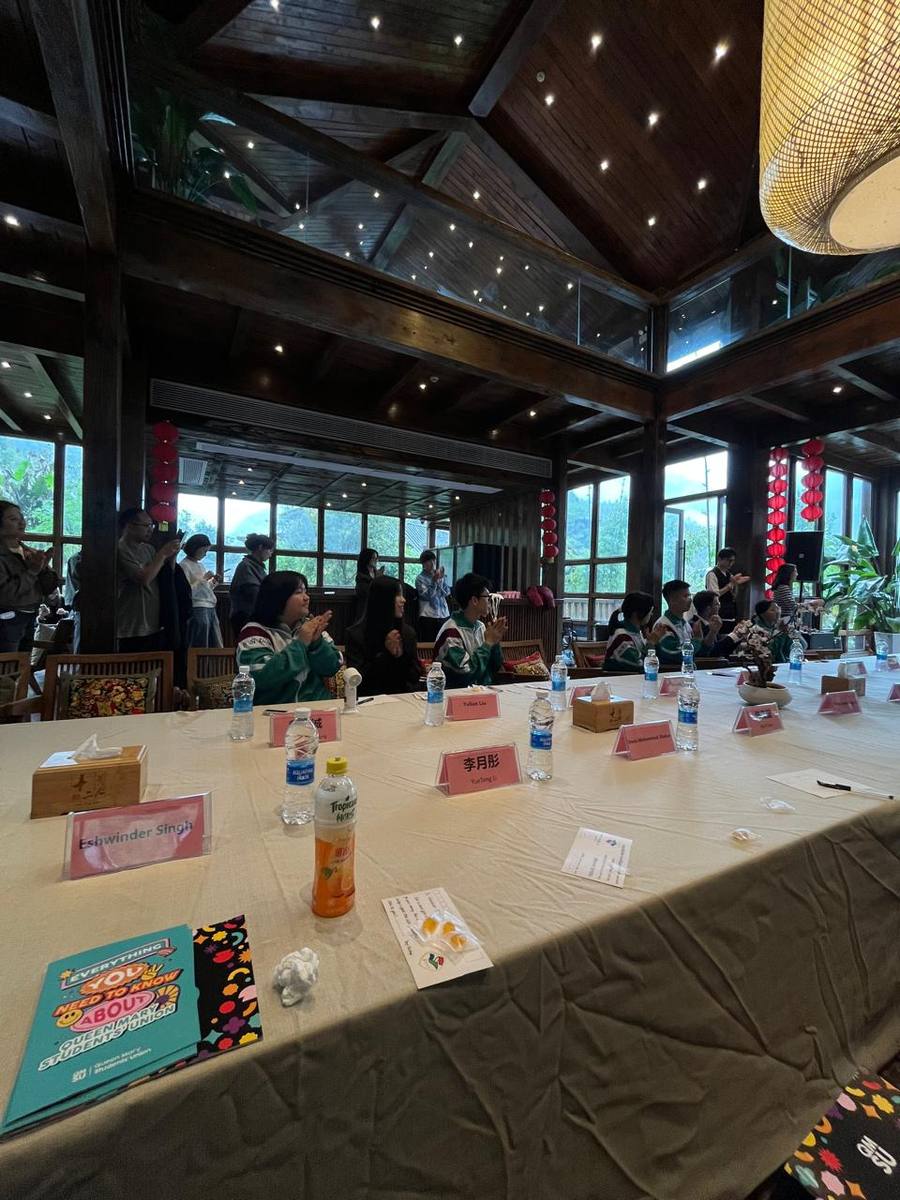 Formal roundtable dinner during the China exchange, with a Queen Mary Students' Union welcome pack on the table
